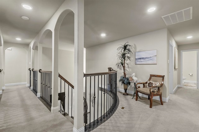 corridor with light colored carpet