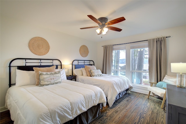 bedroom with dark hardwood / wood-style flooring and ceiling fan