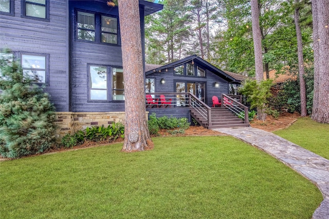 exterior space with a front lawn and a deck