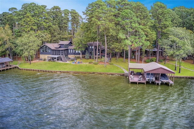 dock area with a water view and a yard