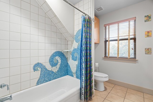 bathroom featuring tile patterned floors, shower / bathtub combination with curtain, and toilet