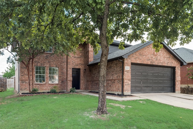 view of front of house featuring a garage and a front lawn