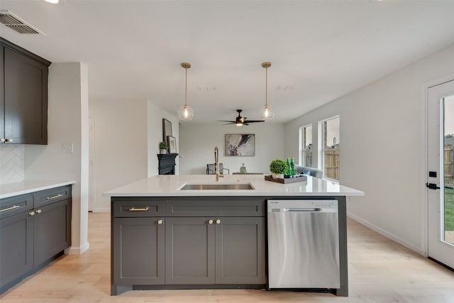 kitchen with stainless steel dishwasher, a wealth of natural light, and sink