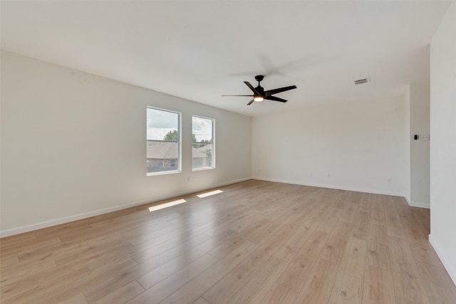 empty room featuring ceiling fan and light hardwood / wood-style flooring