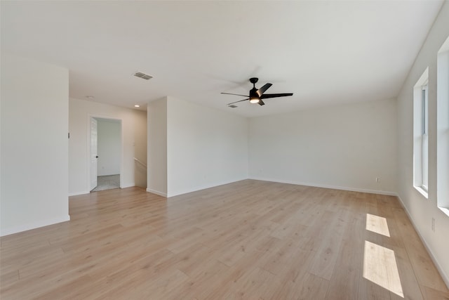 empty room with light wood-type flooring and ceiling fan