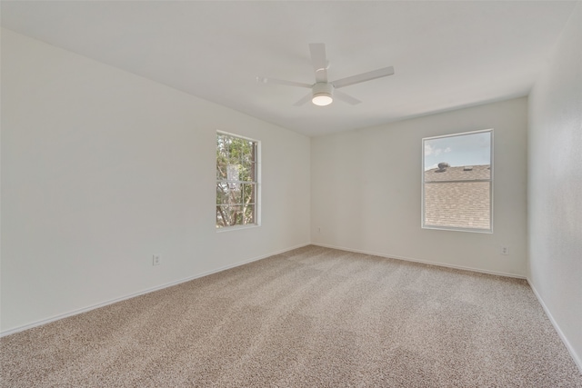 empty room featuring carpet flooring and ceiling fan