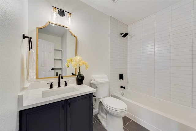 full bathroom featuring tile patterned flooring, tiled shower / bath, toilet, and vanity