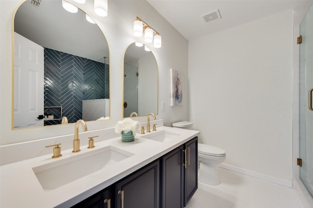 bathroom with a shower with shower door, vanity, toilet, and tile patterned flooring