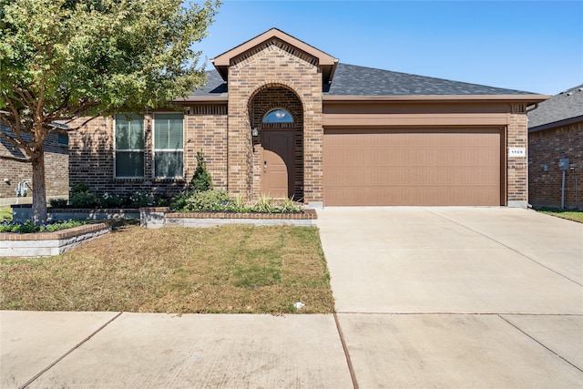 single story home with a garage and a front yard