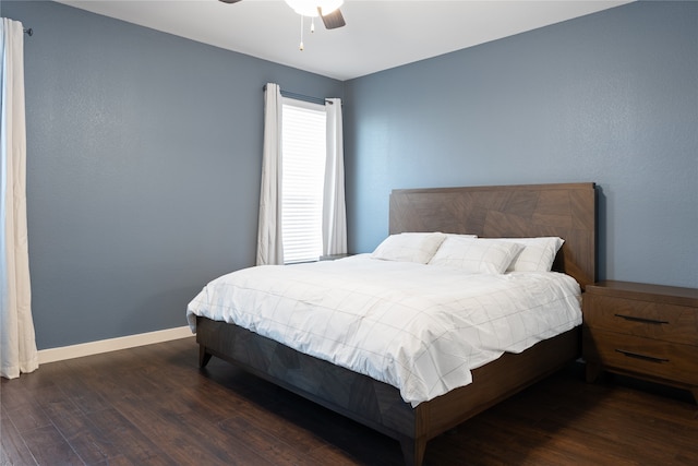 bedroom with dark hardwood / wood-style floors and ceiling fan