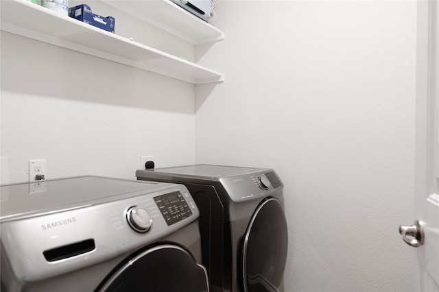 laundry room with washing machine and clothes dryer