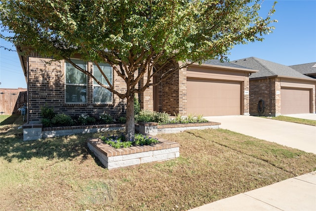 view of front of home with a front lawn and a garage