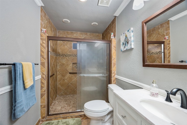 bathroom with toilet, a shower with door, and ornamental molding