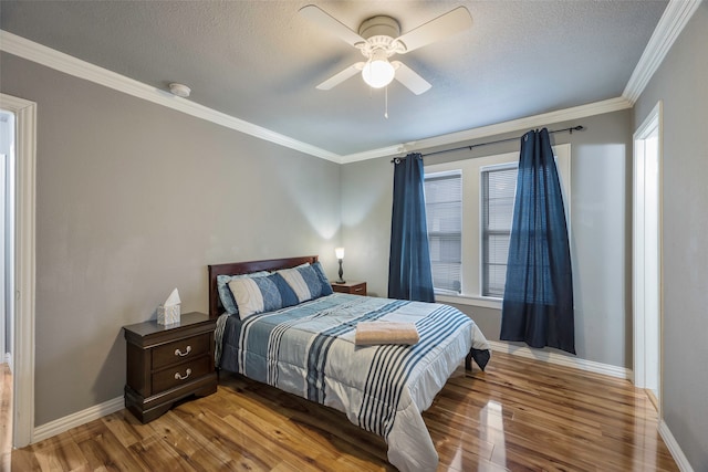 bedroom featuring hardwood / wood-style floors, ceiling fan, and ornamental molding