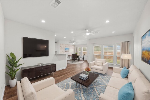 living room with hardwood / wood-style floors and ceiling fan