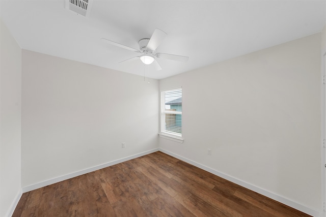 spare room with ceiling fan and dark hardwood / wood-style flooring