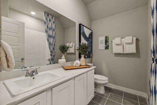 bathroom with tile patterned floors, vanity, toilet, and lofted ceiling