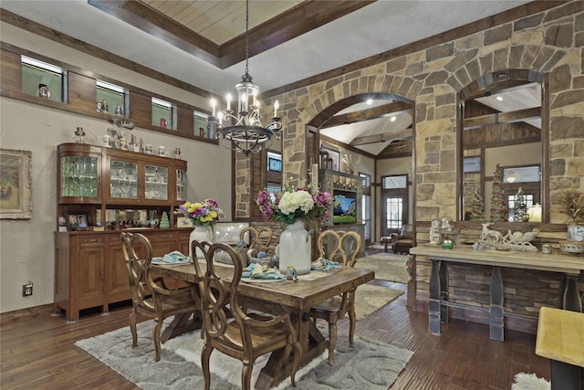 dining space with beamed ceiling, dark wood-type flooring, a chandelier, and a tray ceiling