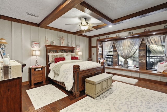 bedroom with hardwood / wood-style floors, beamed ceiling, a textured ceiling, and ceiling fan