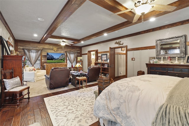 bedroom featuring beamed ceiling, dark hardwood / wood-style floors, and ceiling fan