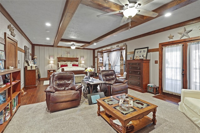 bedroom with beamed ceiling, ornamental molding, ceiling fan, a textured ceiling, and dark wood-type flooring