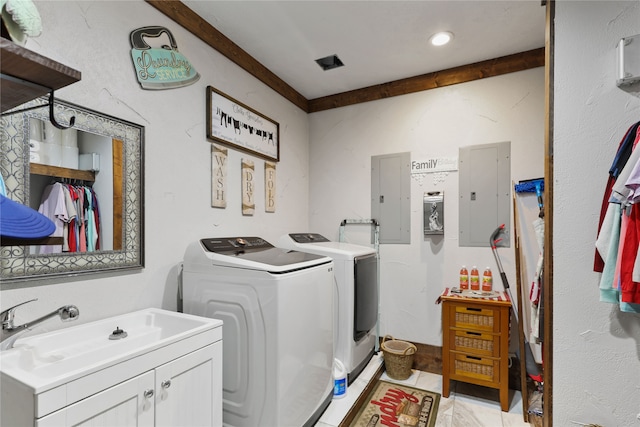 washroom featuring cabinets, electric panel, sink, and washing machine and clothes dryer