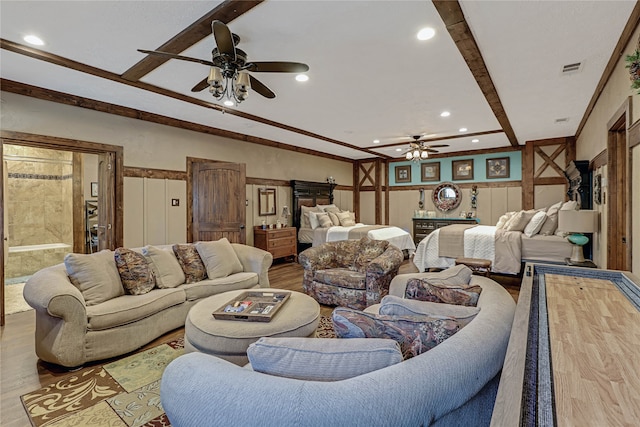 living room featuring beamed ceiling, ceiling fan, and light hardwood / wood-style flooring