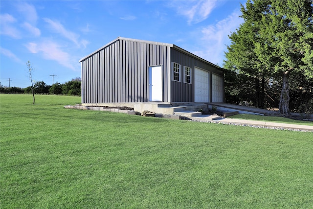 view of outdoor structure featuring a garage and a lawn