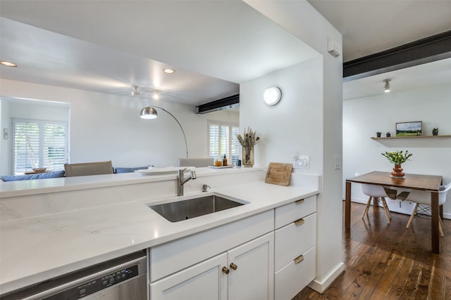 kitchen with white cabinets, plenty of natural light, sink, and dishwasher