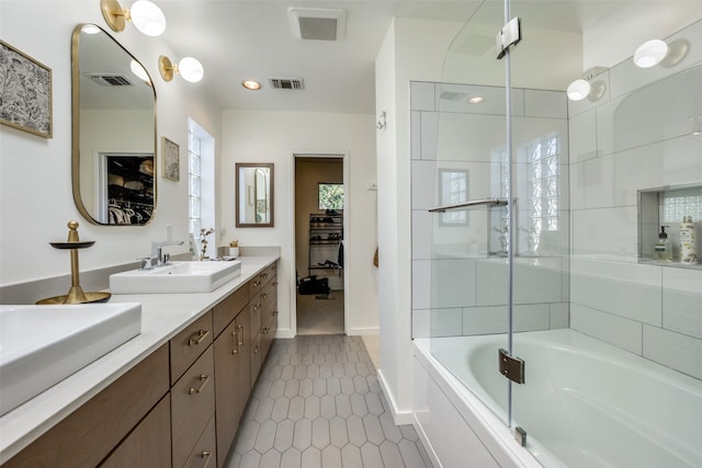 bathroom featuring combined bath / shower with glass door, vanity, and tile patterned flooring