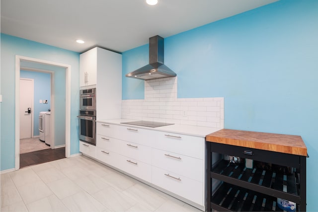 kitchen featuring butcher block counters, white cabinetry, wall chimney exhaust hood, beverage cooler, and decorative backsplash