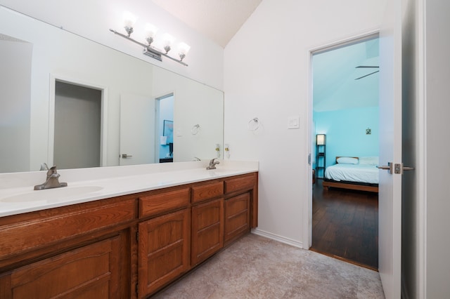 bathroom with hardwood / wood-style floors, vanity, a textured ceiling, and vaulted ceiling