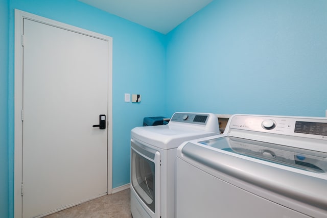 clothes washing area with washing machine and clothes dryer