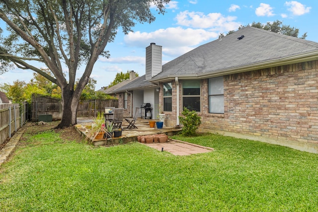 back of property featuring a patio area and a yard