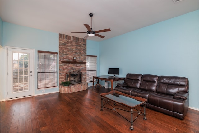 living room featuring hardwood / wood-style floors, a fireplace, and ceiling fan