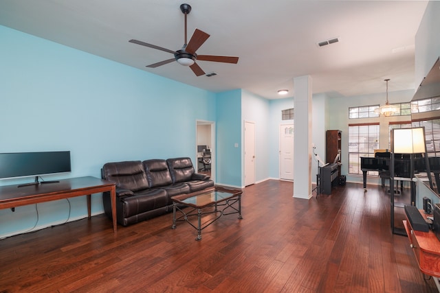 living room featuring dark hardwood / wood-style floors and ceiling fan with notable chandelier