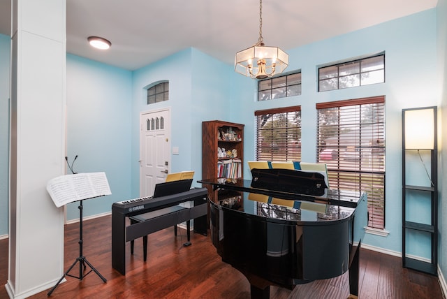 misc room featuring a notable chandelier and dark hardwood / wood-style floors