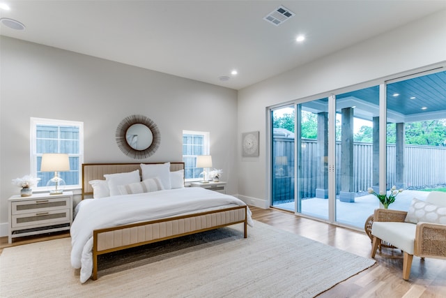 bedroom featuring access to exterior and light wood-type flooring