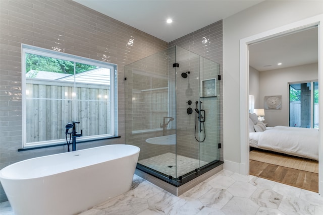 bathroom with shower with separate bathtub