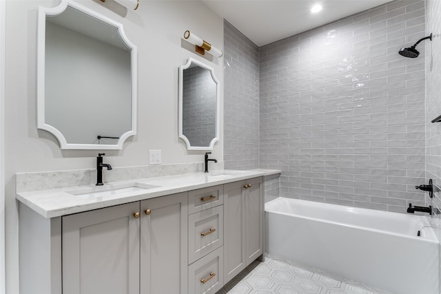 bathroom featuring vanity, tile patterned floors, and tiled shower / bath combo