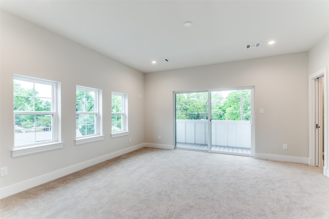 unfurnished room featuring light carpet