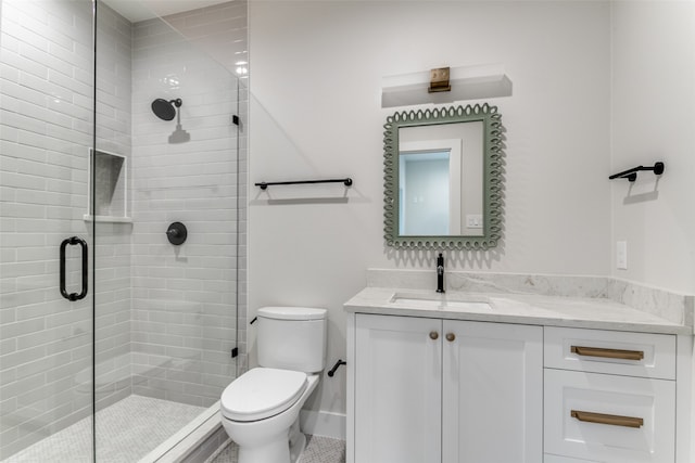 bathroom with toilet, vanity, and walk in shower