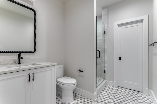 bathroom featuring tile patterned flooring, vanity, toilet, and an enclosed shower