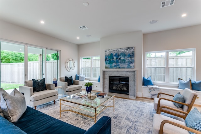 living room featuring a wealth of natural light and light hardwood / wood-style flooring