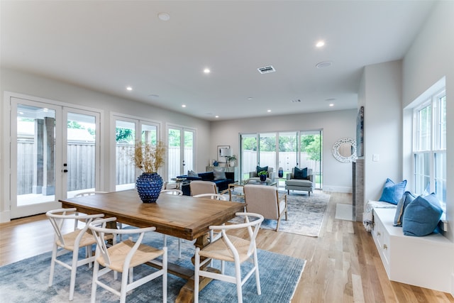 dining area with french doors and light wood-type flooring