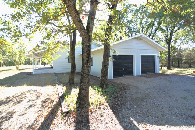 exterior space featuring a garage and an outdoor structure