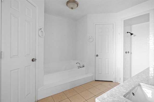 bathroom featuring shower with separate bathtub, vanity, a textured ceiling, and tile patterned floors