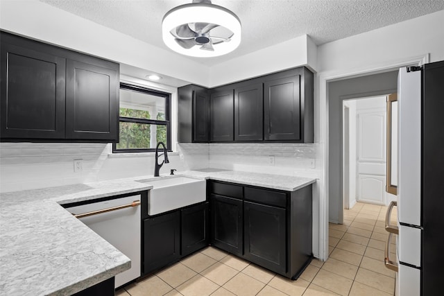 kitchen featuring dishwasher, tasteful backsplash, white refrigerator, and sink