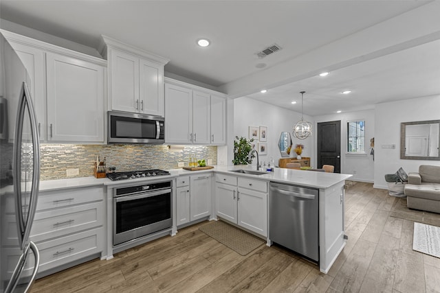 kitchen featuring appliances with stainless steel finishes, sink, light hardwood / wood-style floors, and white cabinets