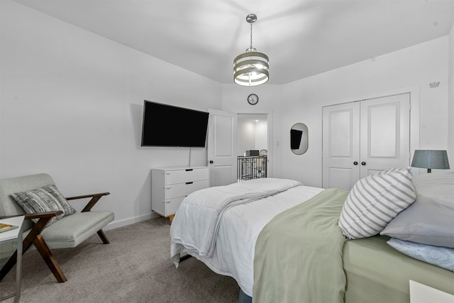 bedroom featuring a closet and light colored carpet